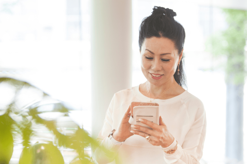 A visitor at home booking their ticket online, on their cell.